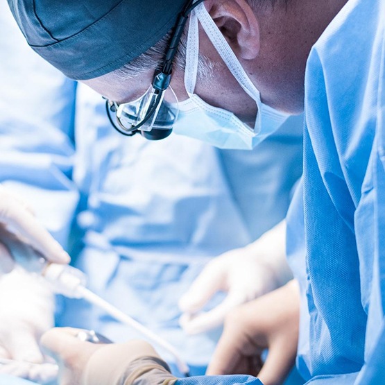 Periodontal team carefully performing surgery