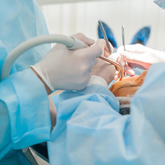 Periodontal team carefully working on patient