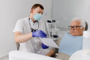 Dentist talking with senior patient about treatment options 
